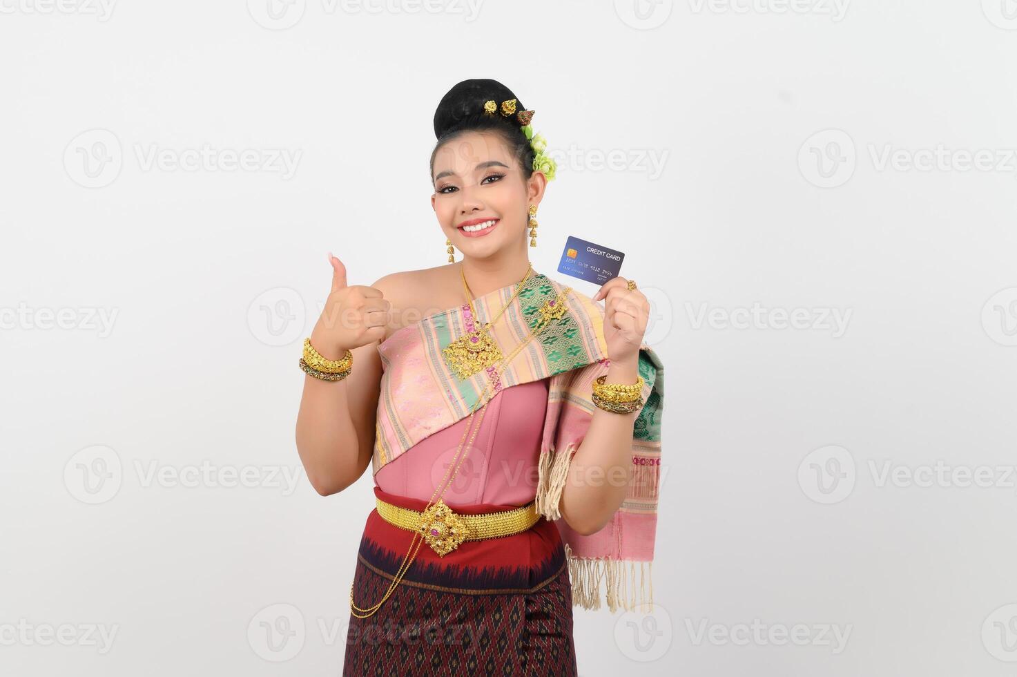 Portrait of Beautiful Thai Woman in Traditional Clothing Posing with credit card photo