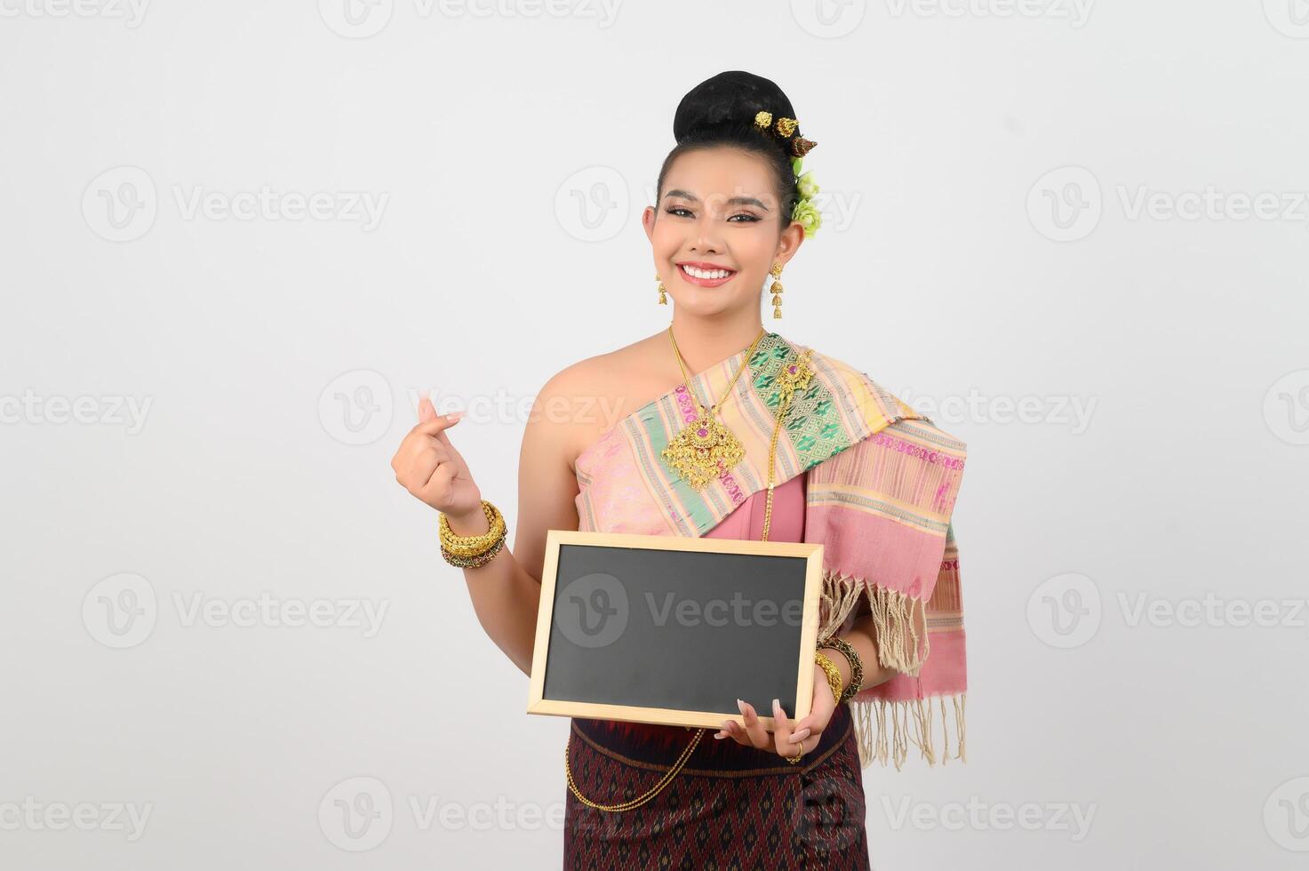 Young beautiful woman in northeastern dress holding chalkboard posting photo