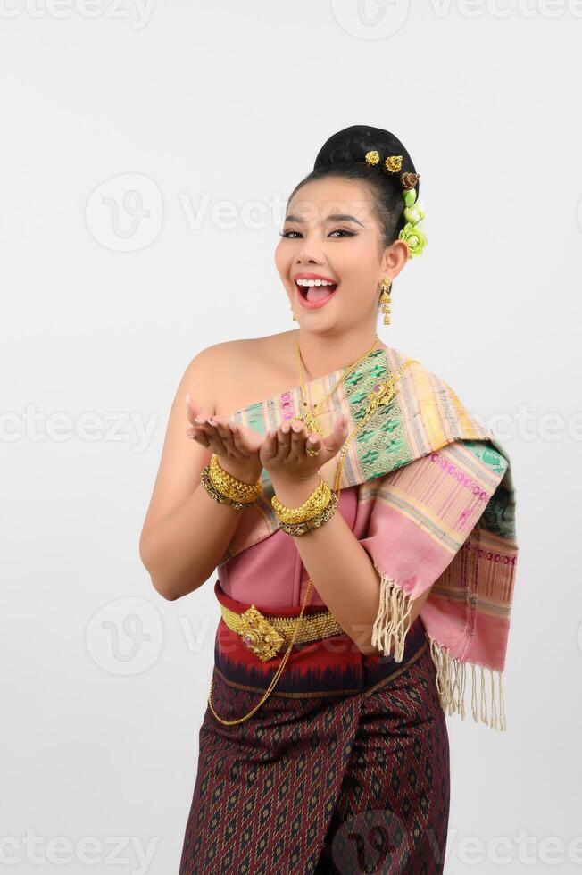 Young beautiful woman in northeastern dress stand and open palm posture photo