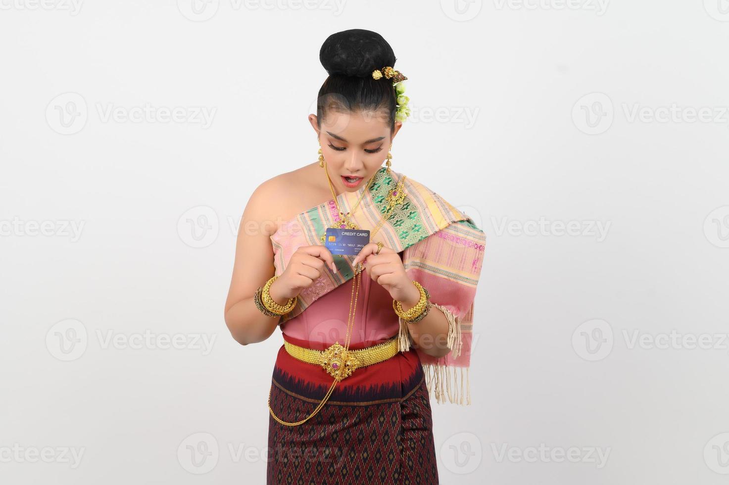 Portrait of Beautiful Thai Woman in Traditional Clothing Posing with credit card photo