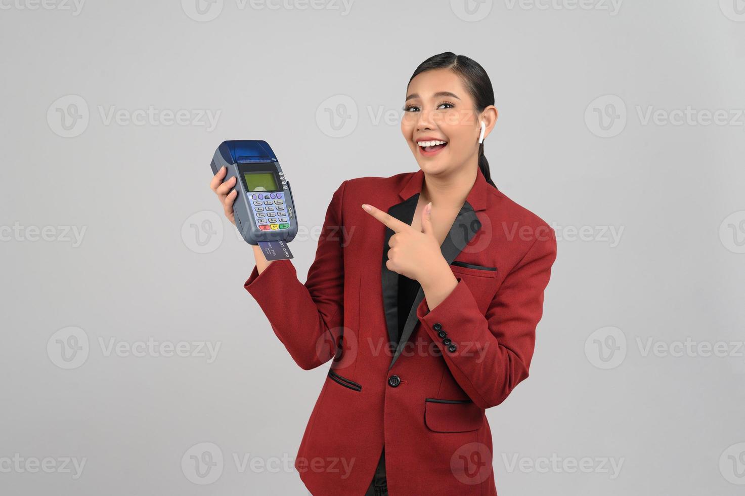 Young beautiful woman in formal clothing for officer with credit card photo