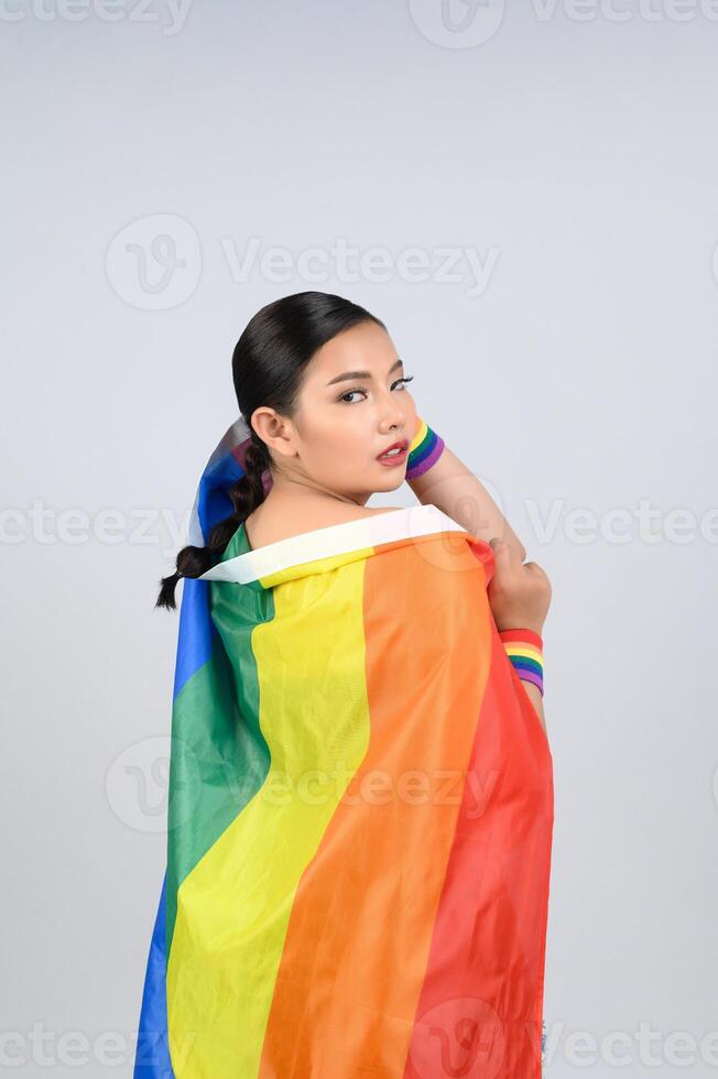 Pretty woman LGBQ pose with muli-color flag photo