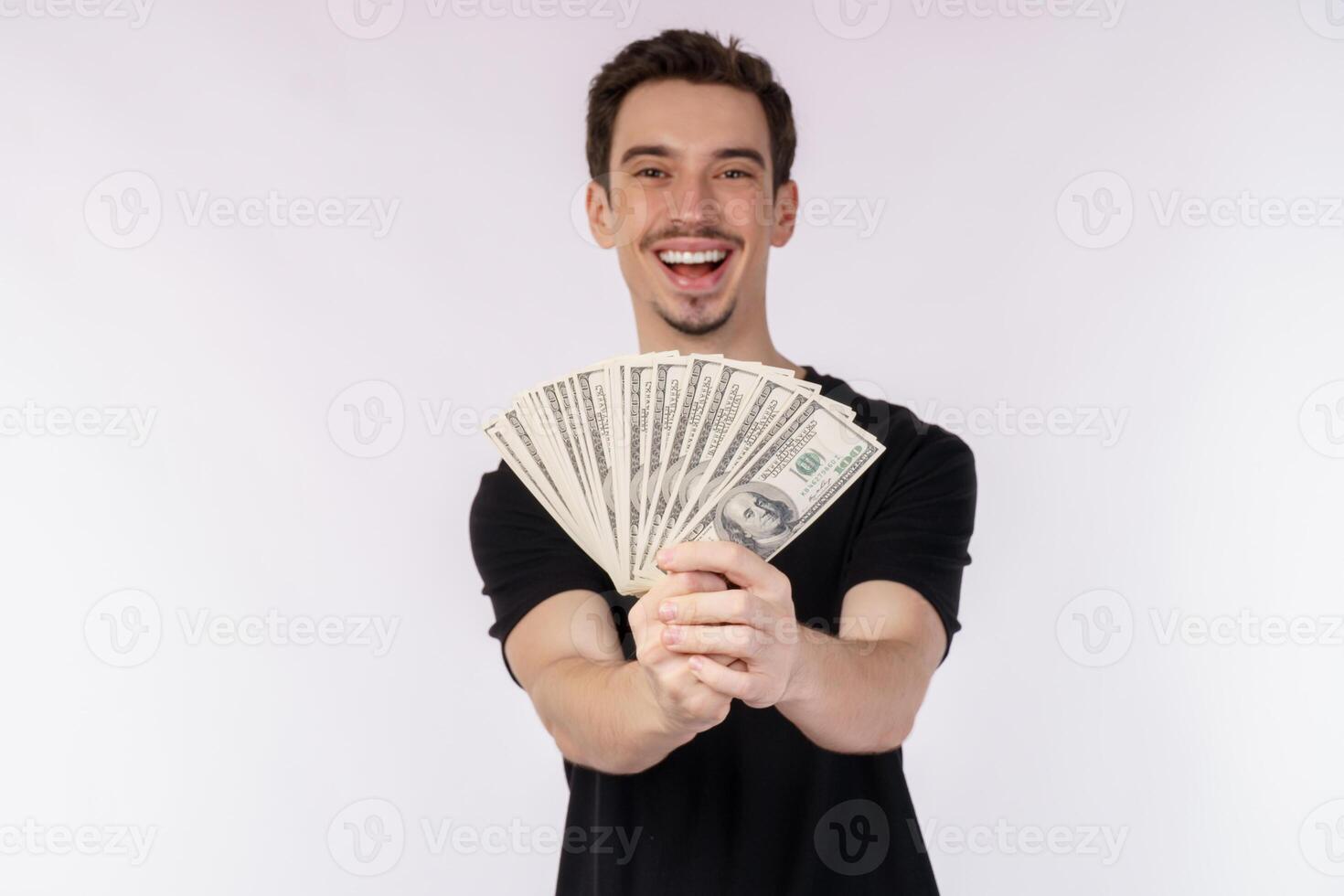 Portrait of a cheerful man holding dollar bills over white background photo