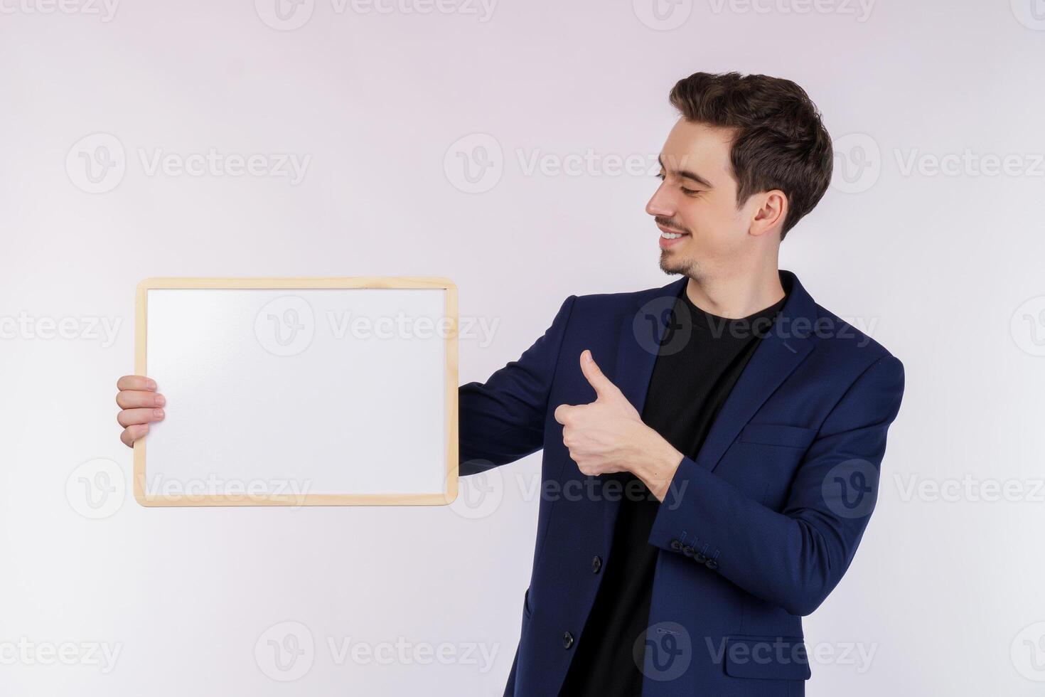 Portrait of happy businessman showing blank signboard on isolated white background photo