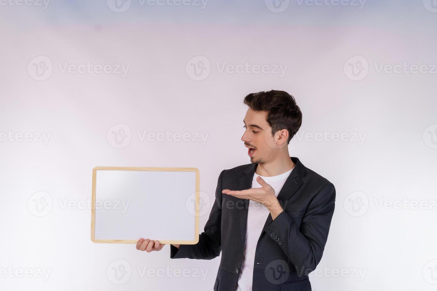 Portrait of happy businessman showing blank signboard on isolated white background photo