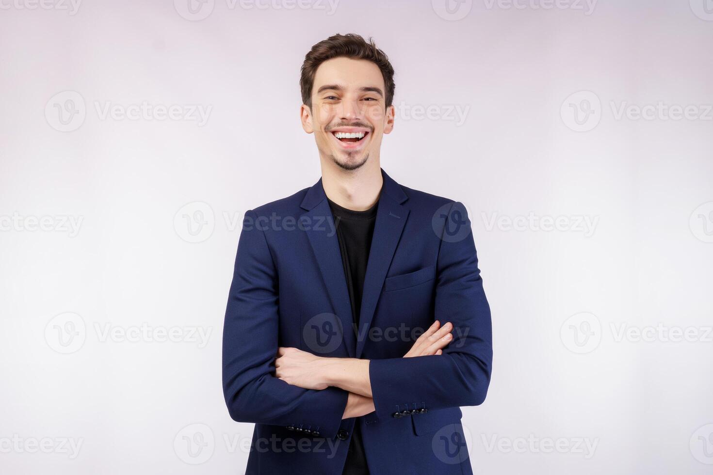 Portrait of young handsome businessman wearing suit standing with crossed arms with isolated on studio white background photo