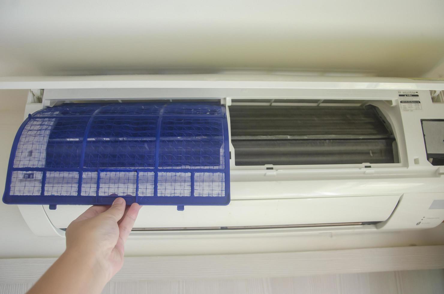 Clean the air conditioner filter from dust in the bedroom, prevent respiratory diseases or allergies. photo