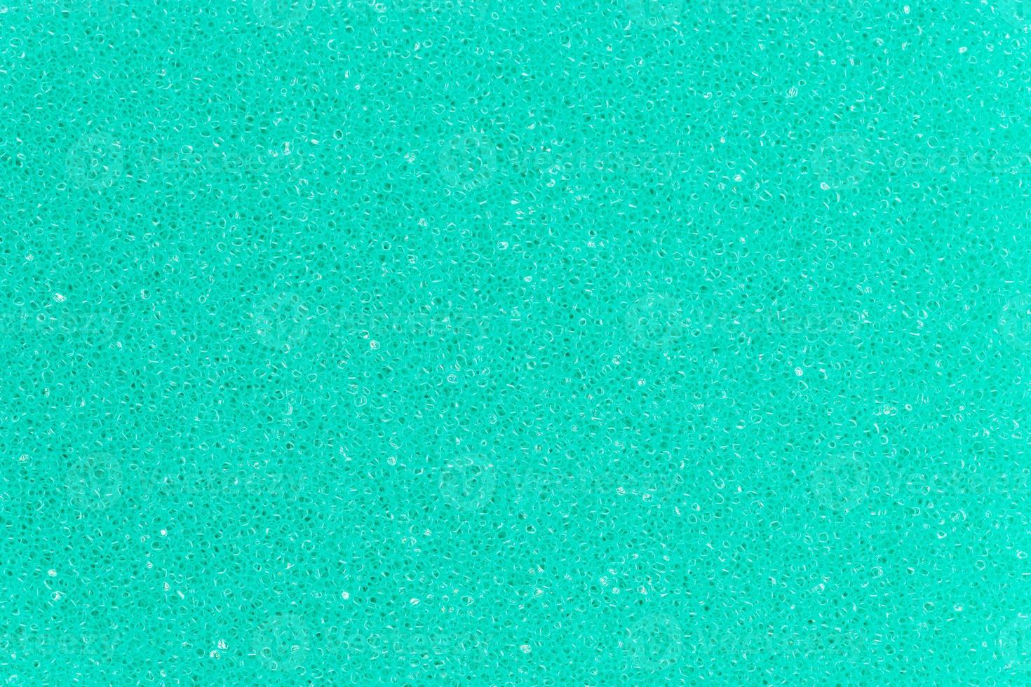 Turquoise color foam sponge porous texture background. Extreme close-up view of detail abstract synthetic material. Horizontal composition photo
