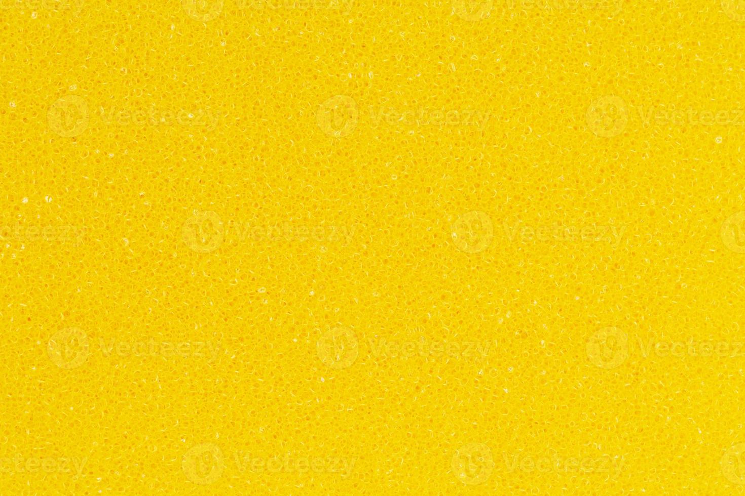 Bright yellow color foam sponge porous texture background. Extreme close-up view of detail abstract synthetic material. Horizontal composition photo