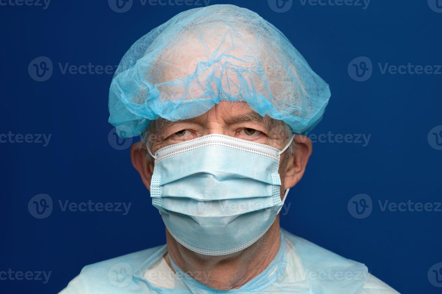 Portrait of senior adult dressed in surgical face mask, covering nose and mouth from SARS, virulently infectious disease corona virus photo