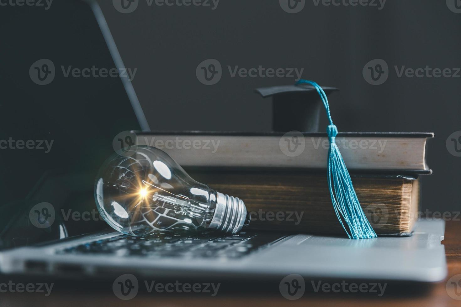 Light bulbs and books with graduation hat. Concept of reading books, knowledge, and searching for new ideas. Innovation and inspiration, Creativity with twinkling lights, the inspiration of ideas. photo