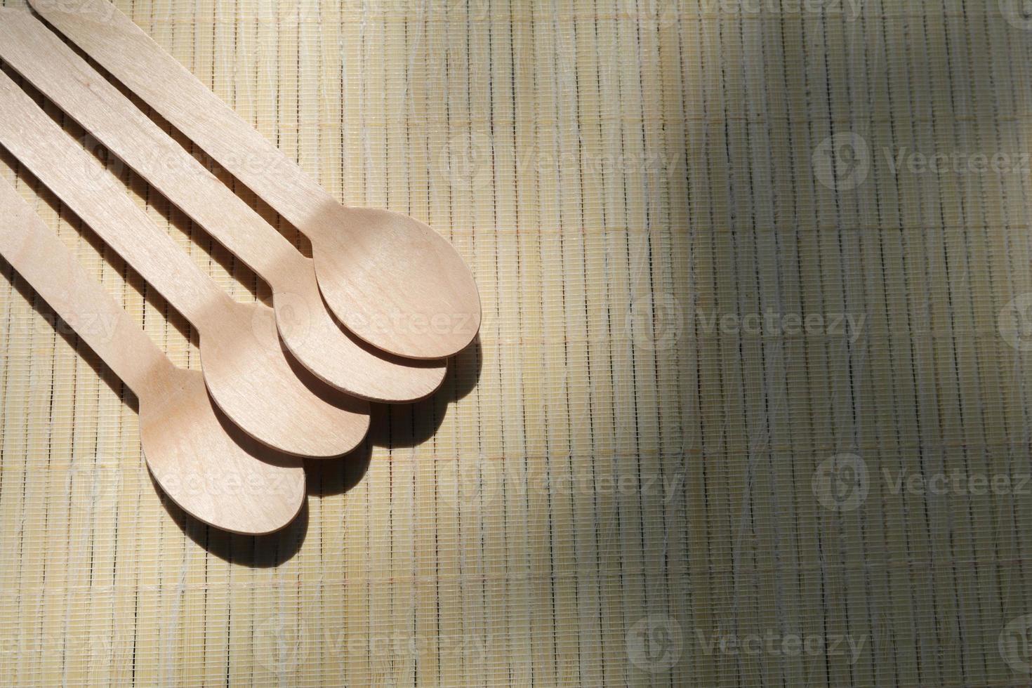 wooden spoon, natural wood utensils, are eco-friendly - one-use, disposable and safe for health, and offers a new writing area and design. photo