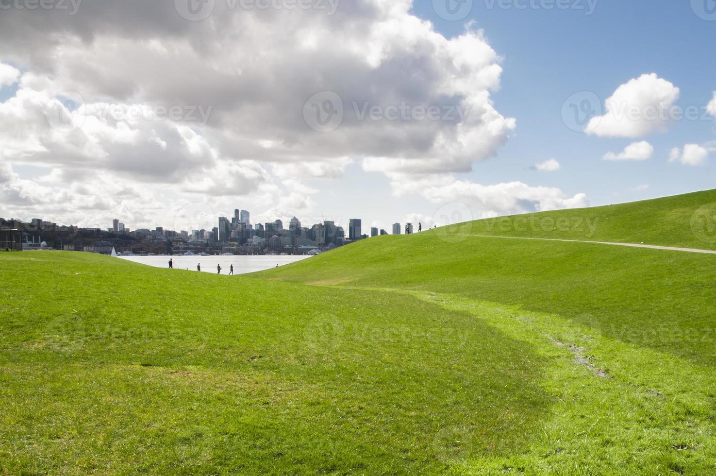 Grassland and Seattle under dramatic clouds photo