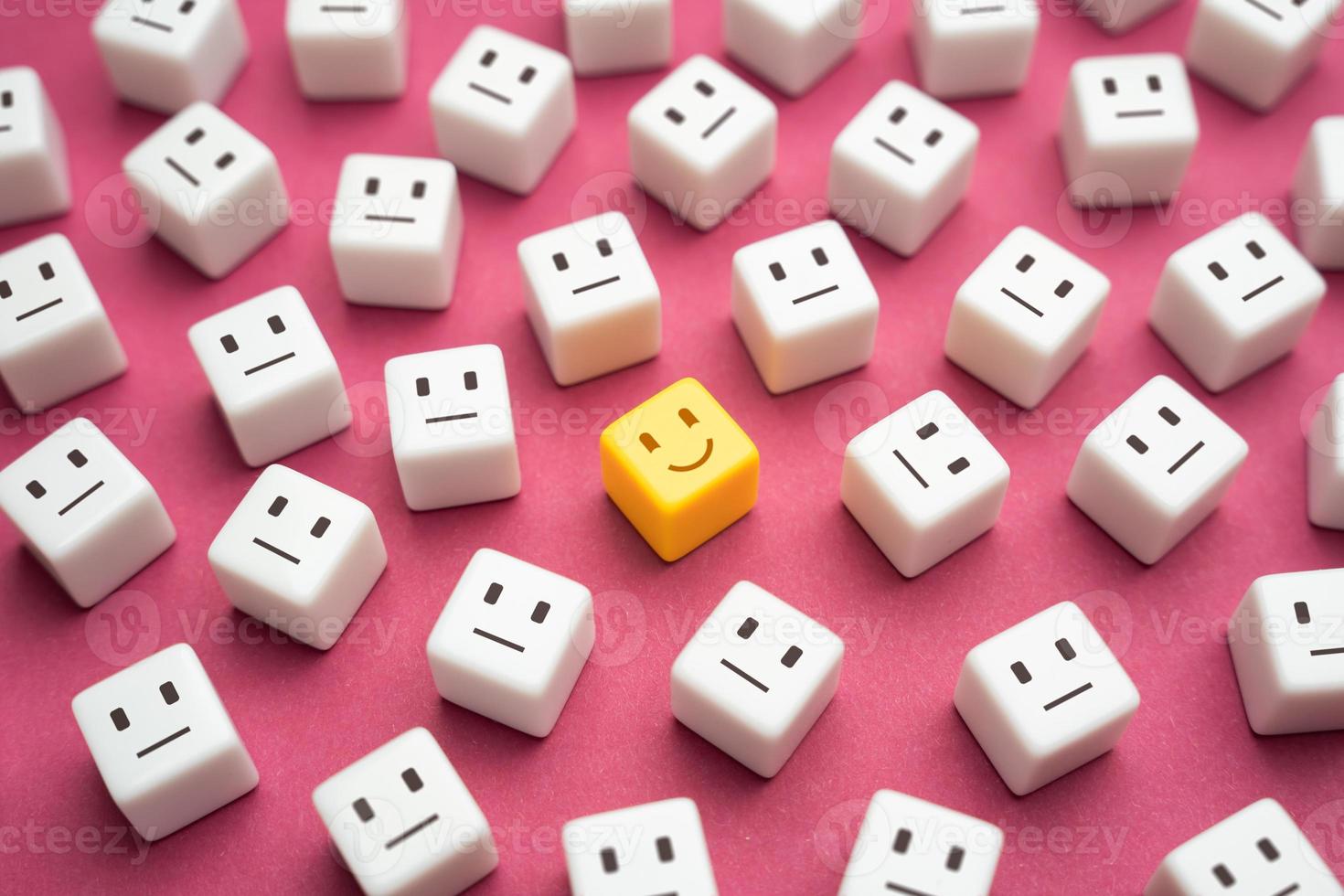 Smiling yellow amprophomorphic face among many indifferent neutrals. One of the kind. Inspiration and optimism. Good mood. Feeling great. photo