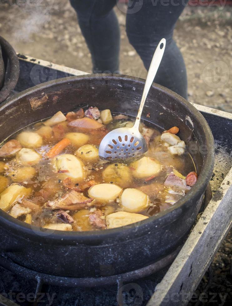 Serbian traditional stew cooked in big pots photo