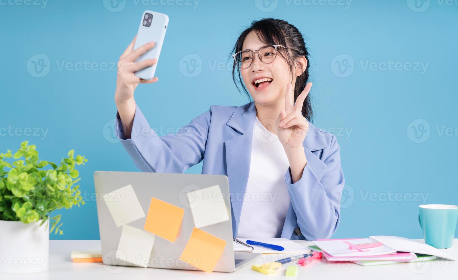 Young Asian businesswoman working on background photo