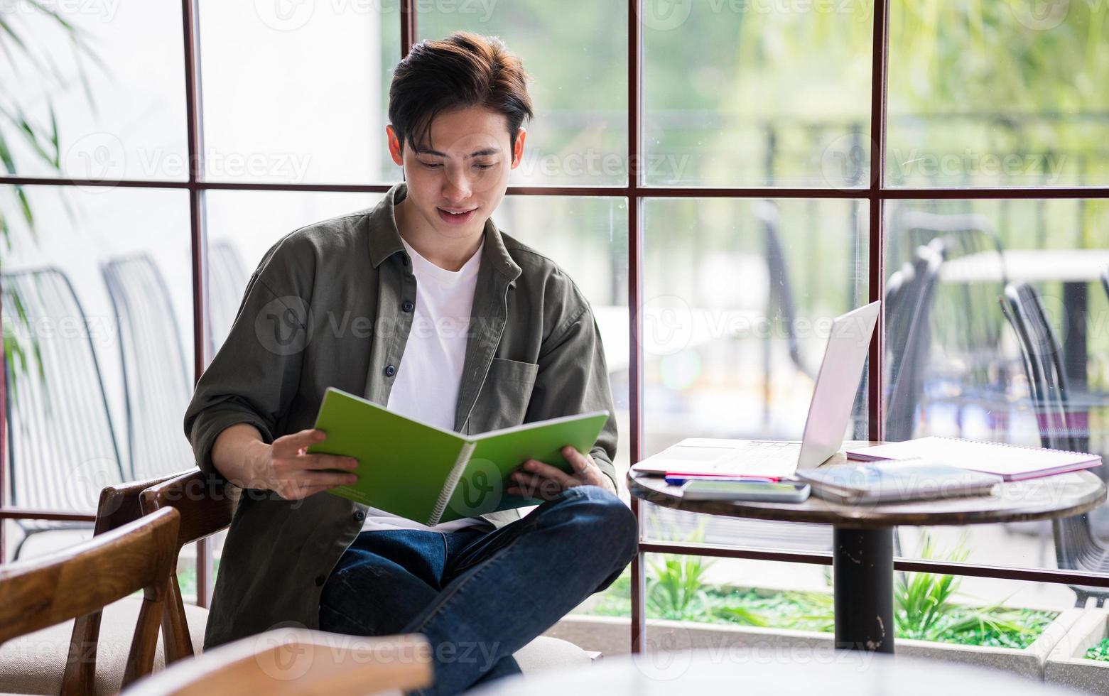 Young Asian businessman working at coffee shop photo