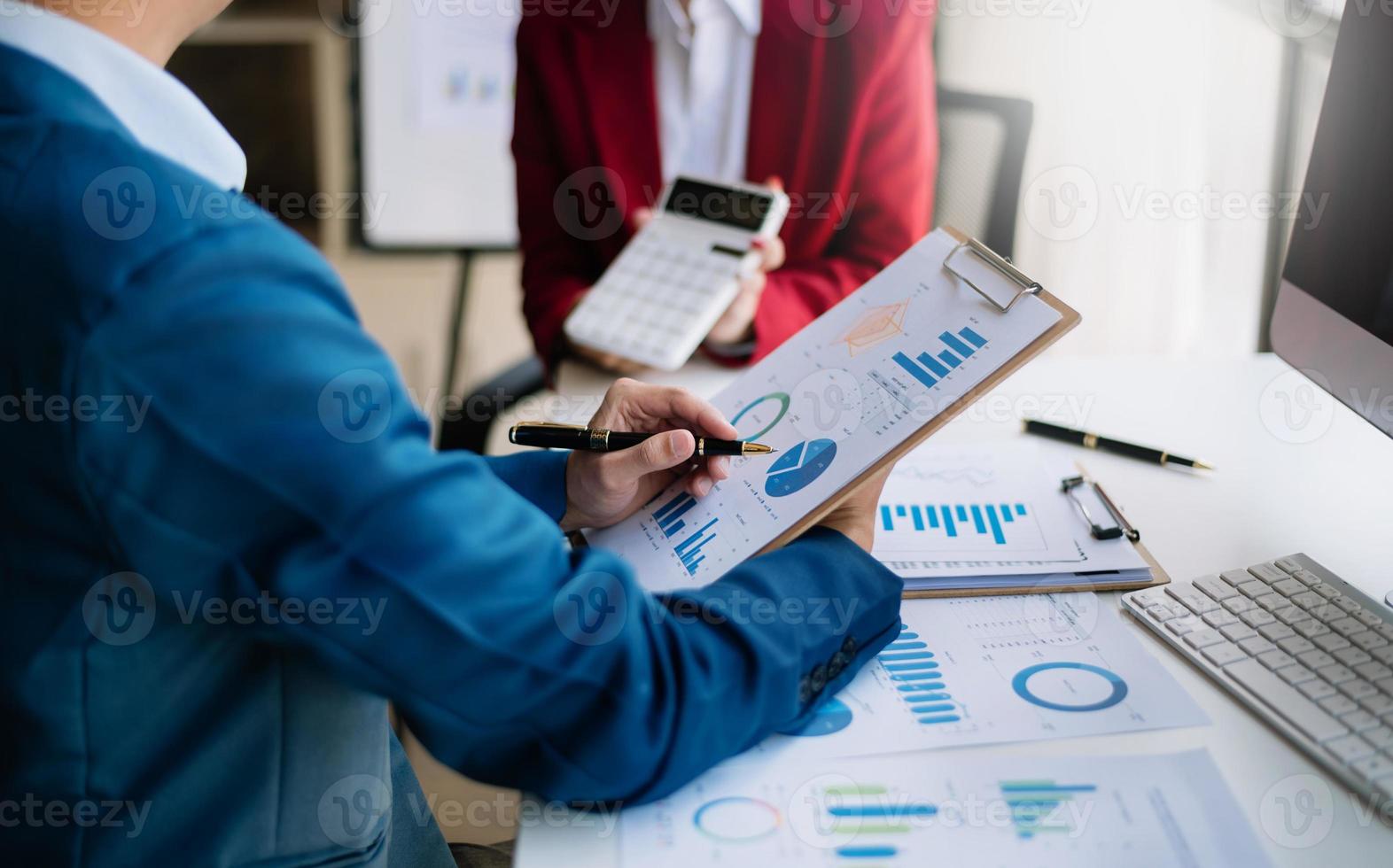 Team business meeting presentation. Hand businessman working project in modern office.Laptop, calculate  and tablet and smart phone on white desk in morning light photo