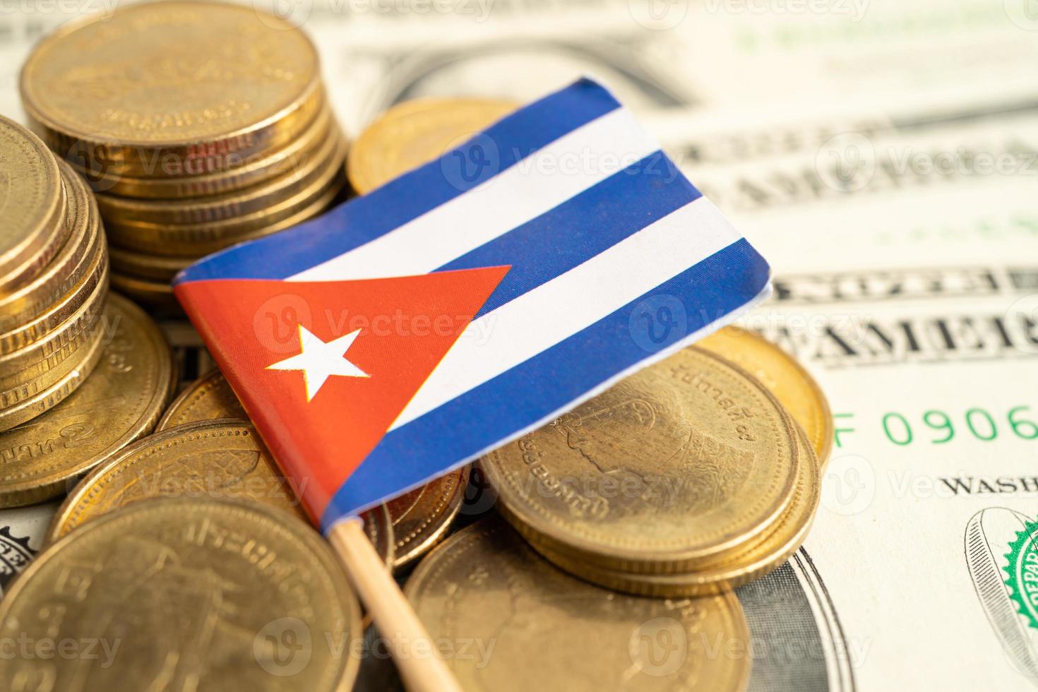 Stack of coins with Cuba flag and US dollar banknotes. photo