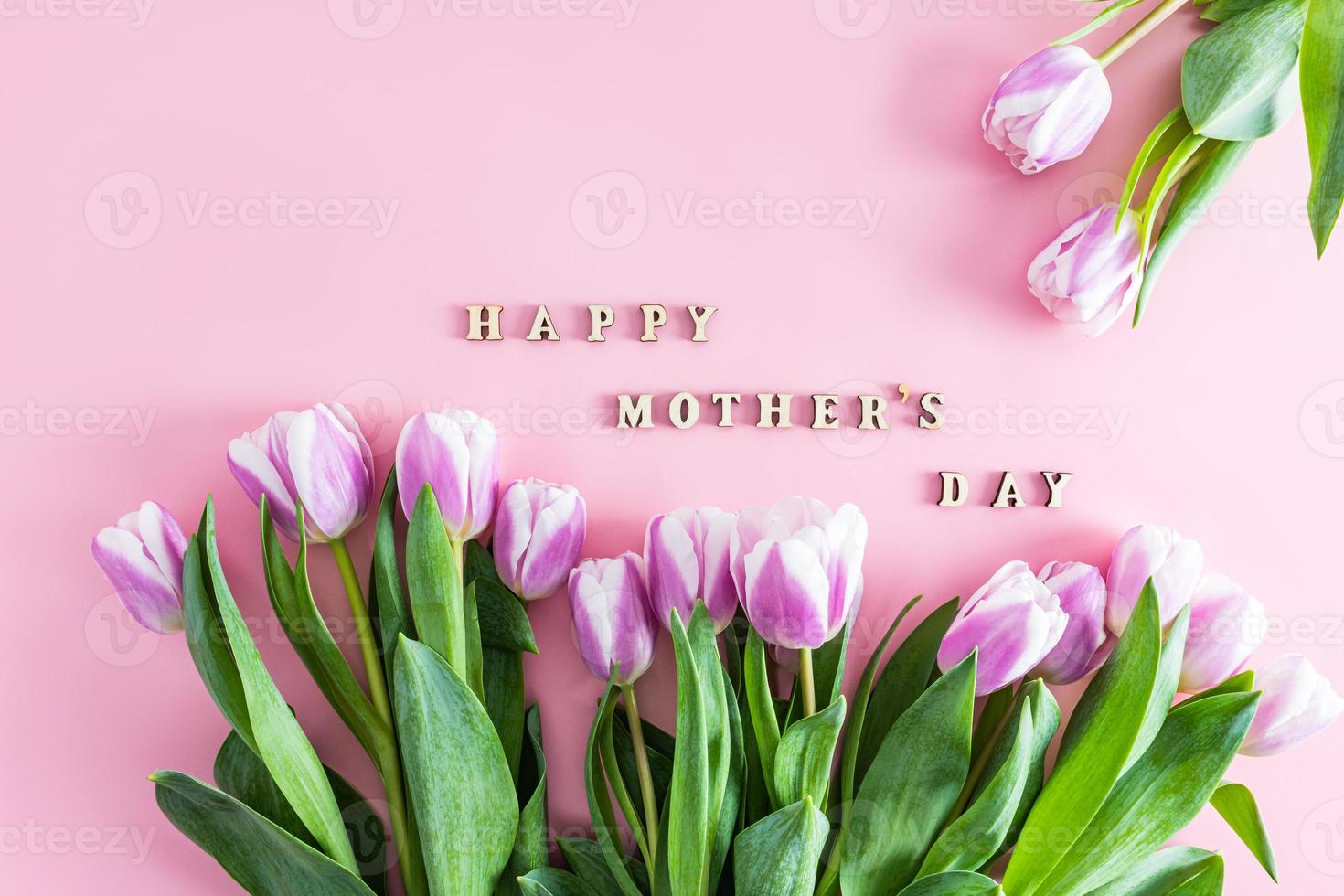 festive spring background for the Mother's Day holiday. lilac tulips and text in wooden letters happy mother's day. poster. postcard. photo