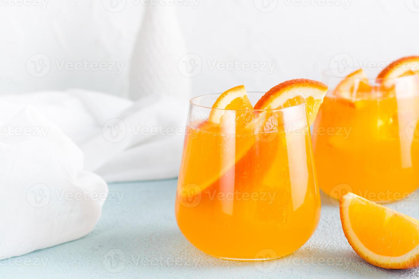 Hard seltzer refreshing orange cocktail in glasses on a table. Homemade drink. Copy space photo