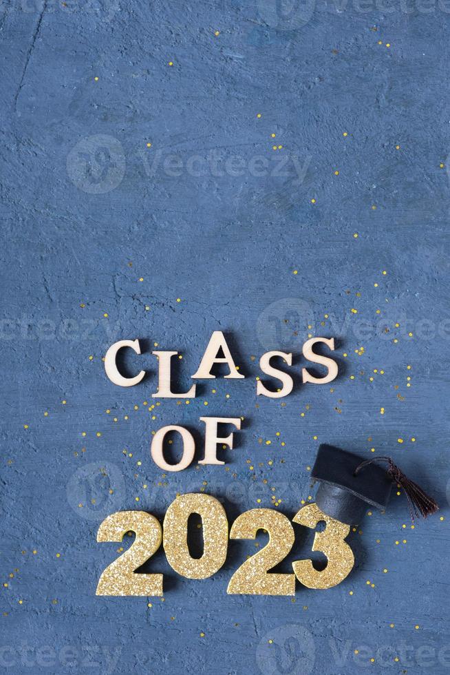 Graduated 2023 concept. Class of 2023 text with graduate cap on dark background with bokeh photo
