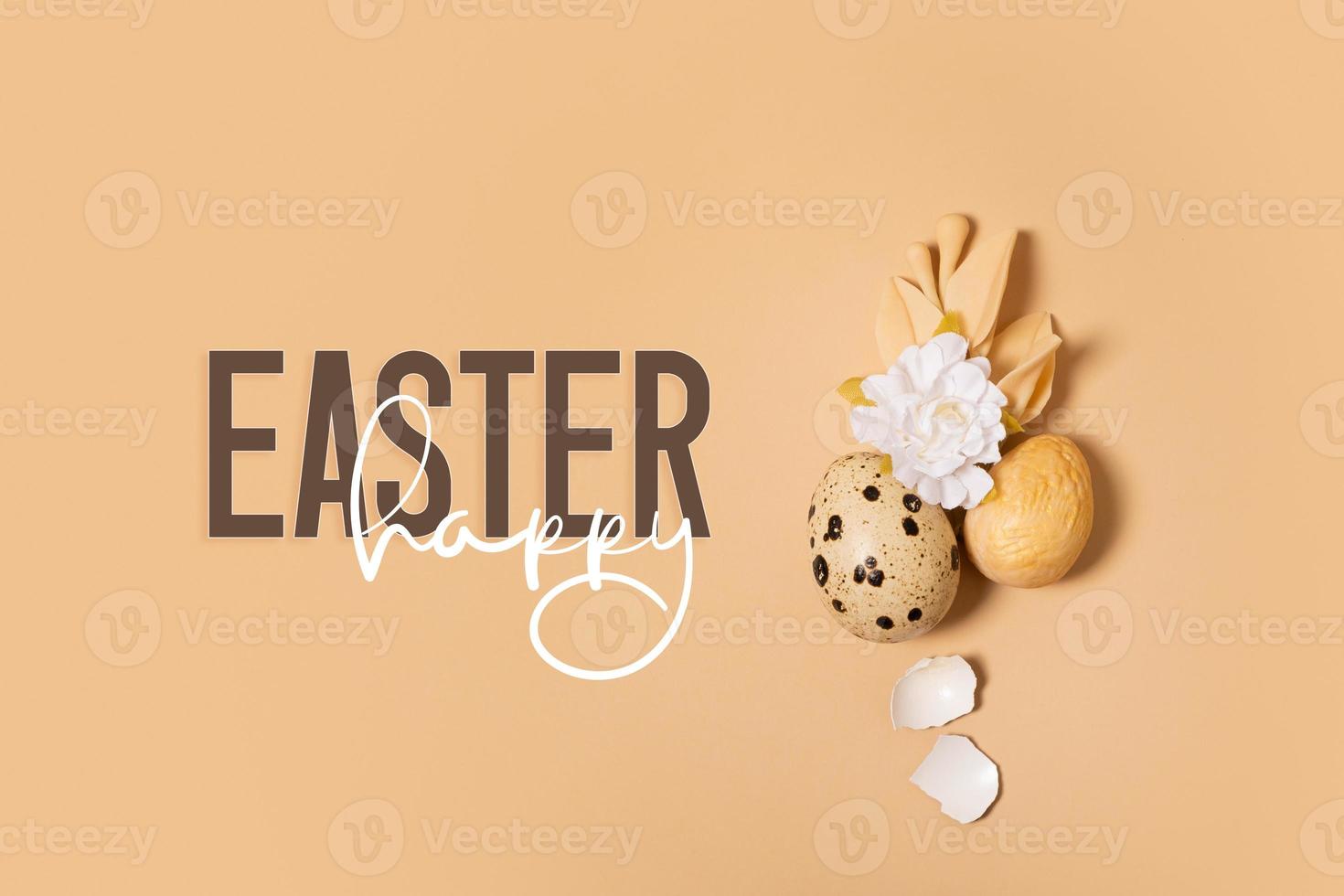 Happy Easter text with easter eggs and flowers composition. Easter greeting card photo