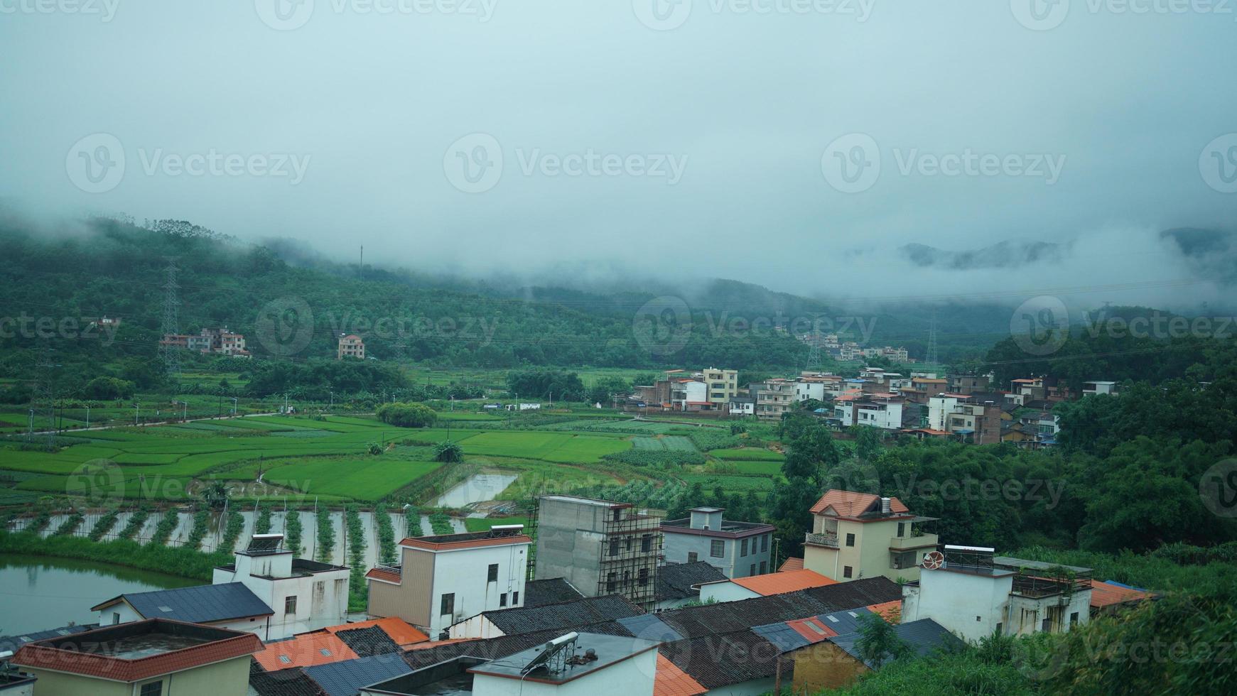 The beautiful countryside view from the runny train on the south of the China in the rainy day photo