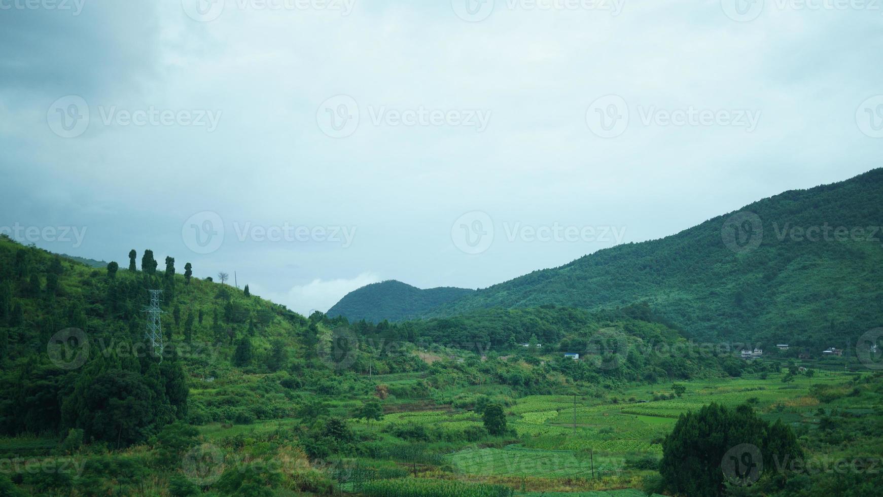 The beautiful countryside view from the runny train on the south of the China in the rainy day photo