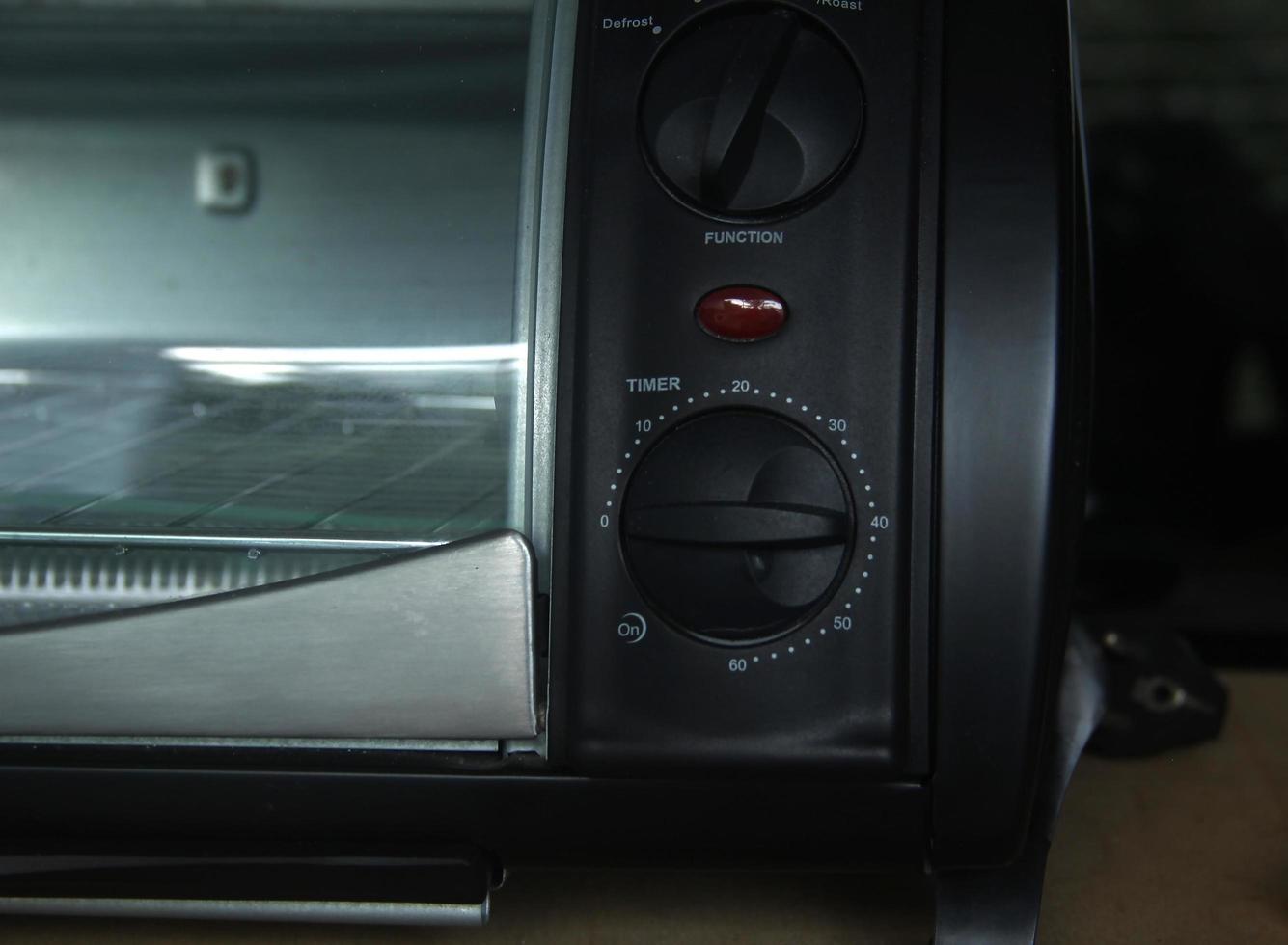 Black oven microwave timer button close up isolated on rectangle