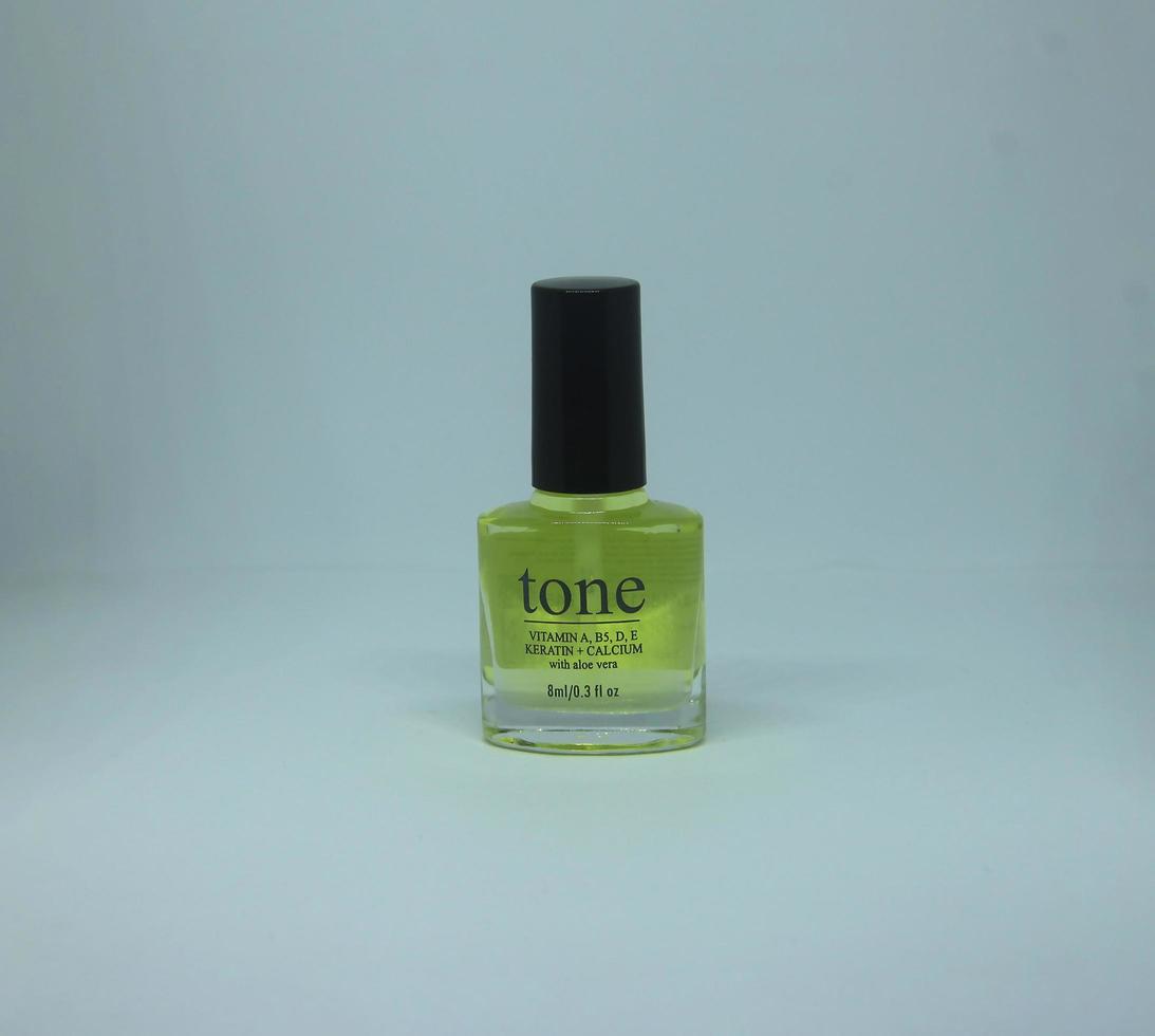 Central Jakarta, Indonesia - March 12th, 2023 - Tone nail vitamin with keratin and calcium. Safe to use daily nail product. Vitamin kuku tone with kalsium in compact glass nail polish bottle shape. photo