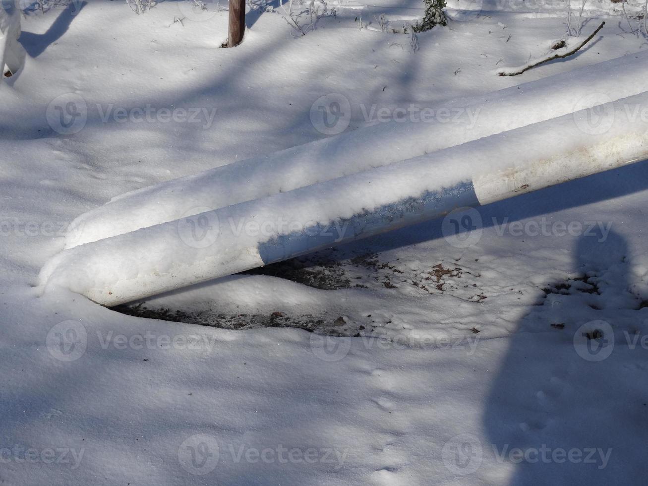 Blue and white obstacle bars covered with snow photo