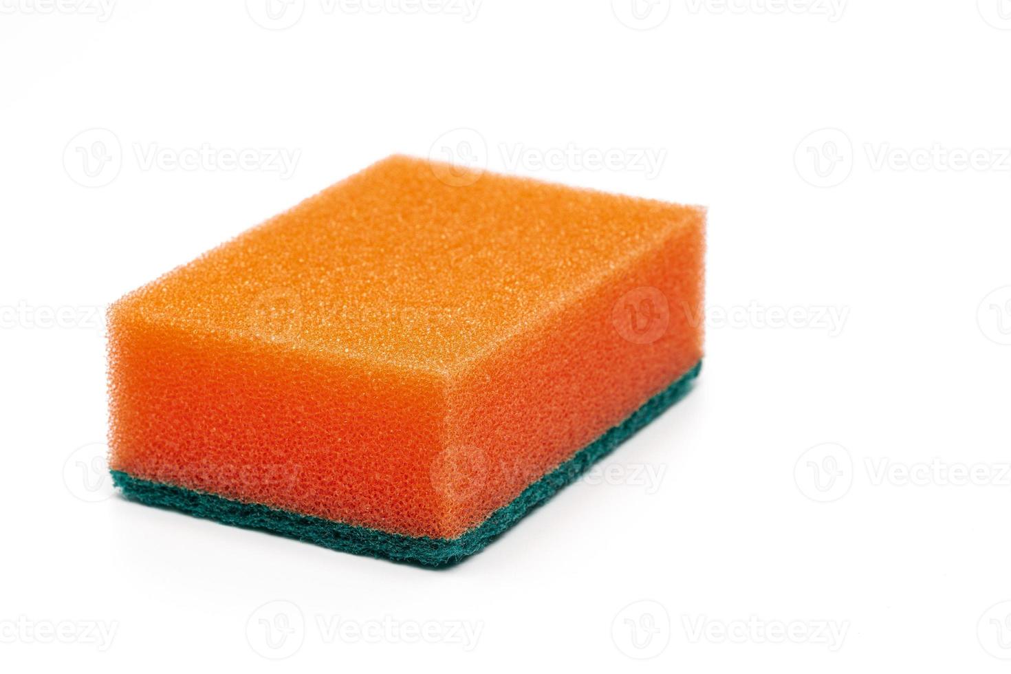 Foam sponge of orange color with abrasive material used daily by all housewives to clean house photo