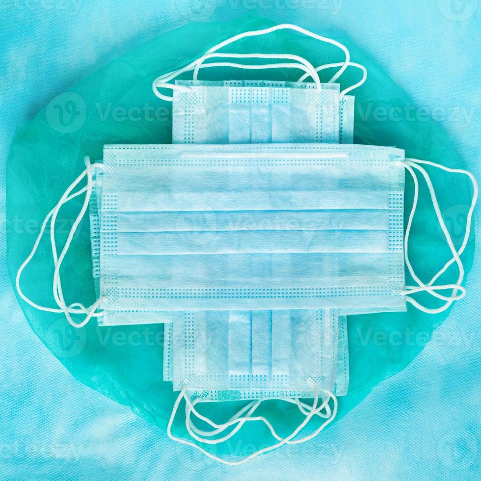 Group of antiviral protective face masks on blue medical background photo