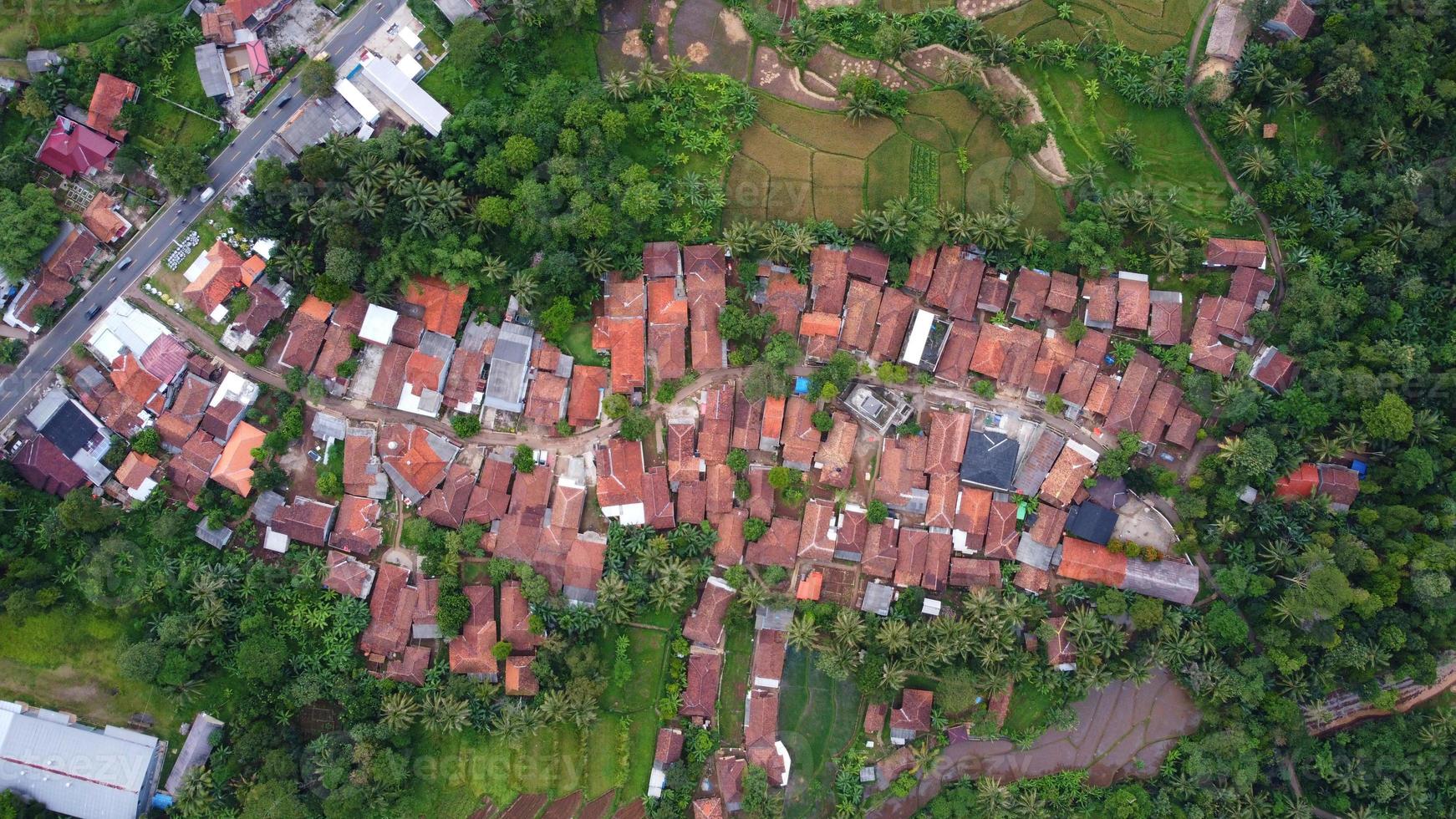 Drone photos from above view of beautiful village houses. Surrounded by lots of trees and close to the main road