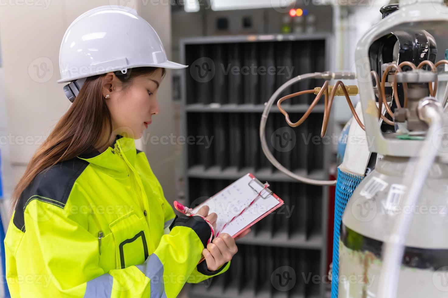 Asian engineer working at Operating hall,Thailand people wear helmet  work,He worked with diligence and patience,she checked the valve regulator at the hydrogen tank. photo