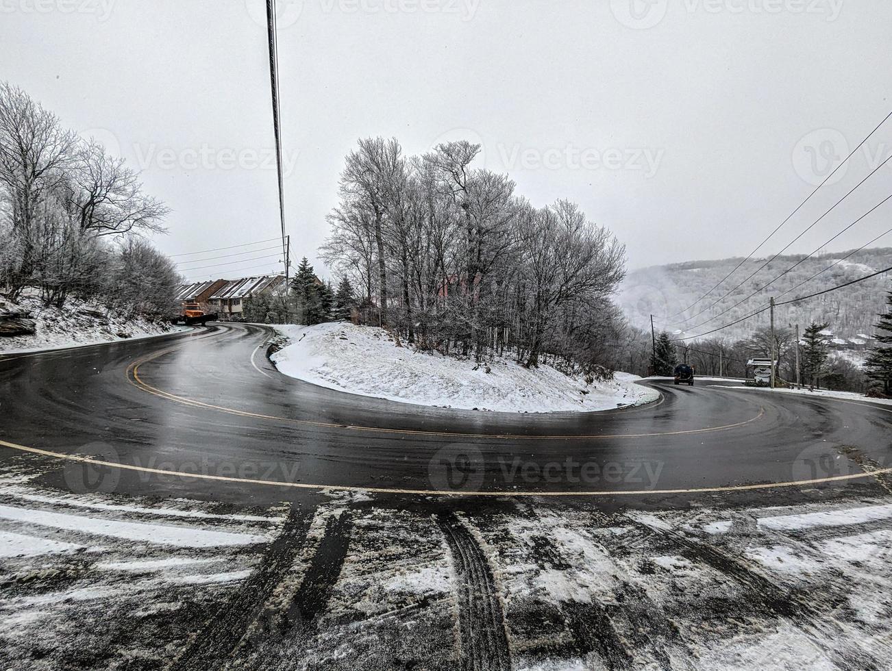 large snow plow truck clearing roads in the mountains photo