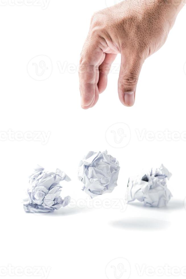 Hand taking a crumpled paper ball isolated photo