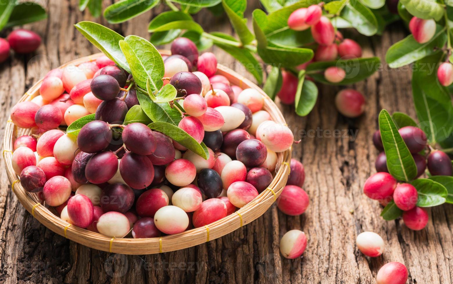 carunda fruit on old wood background photo