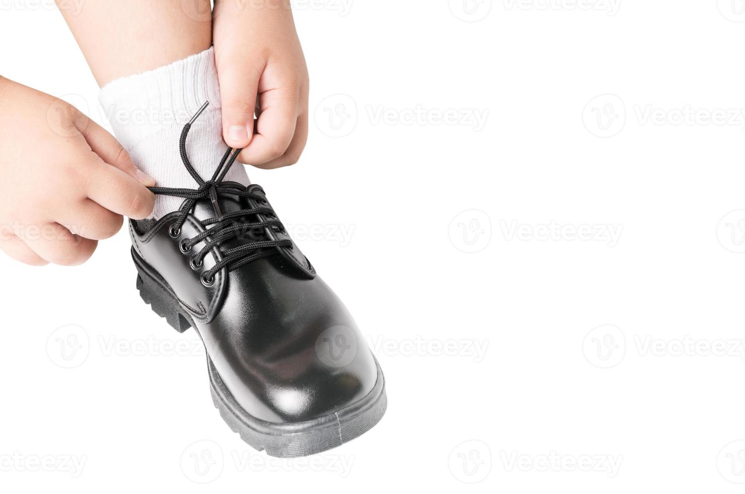 Thai boy is tying the laces student shoe photo