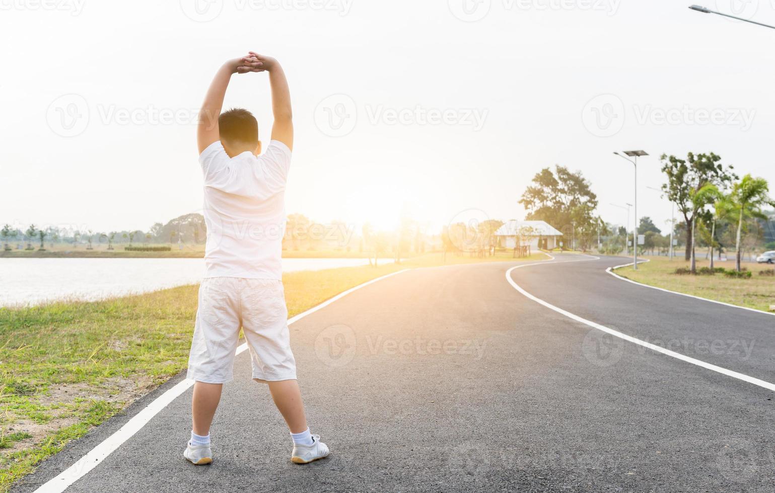 Obese fat boy exercise at park on morning photo