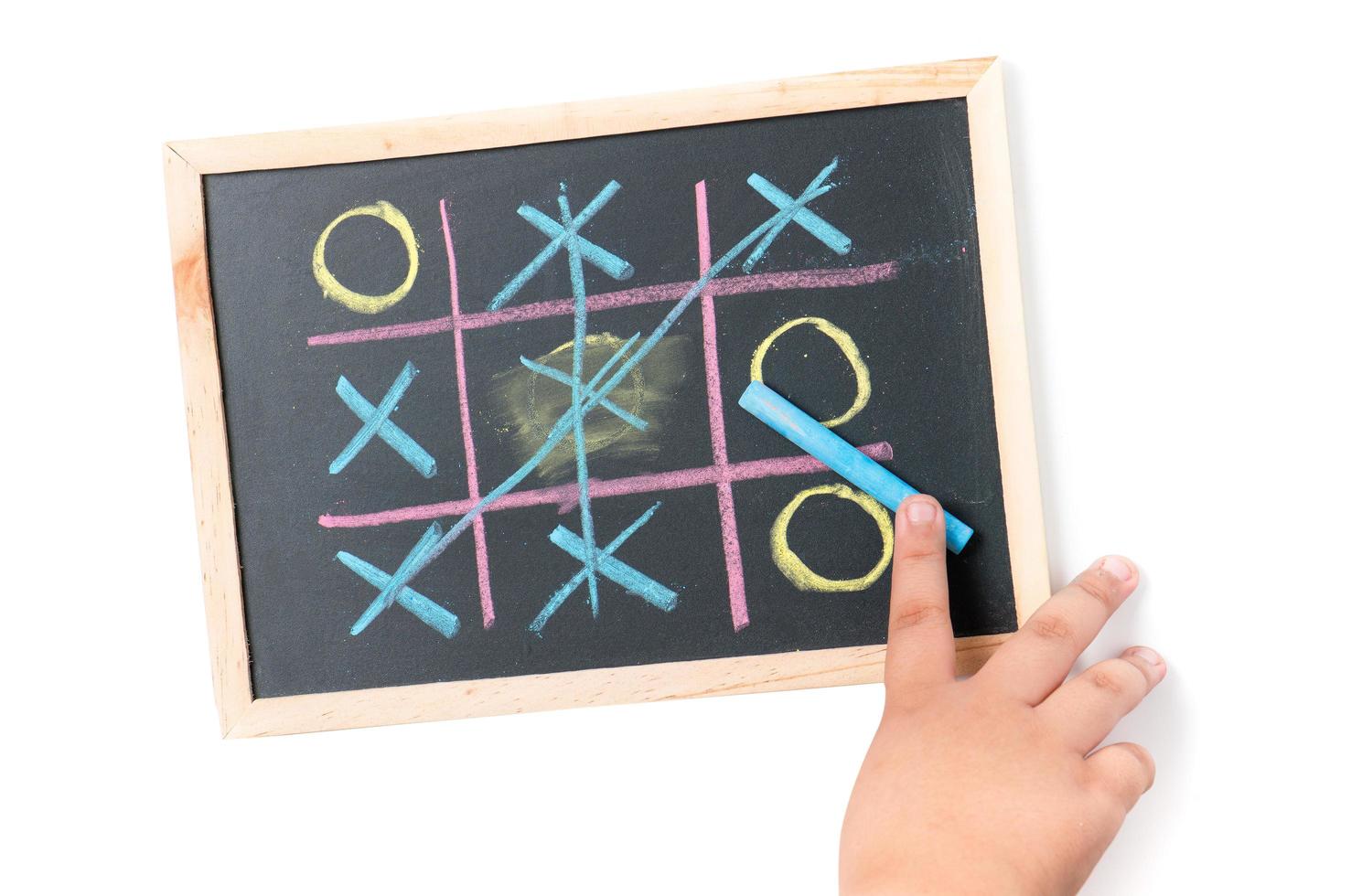 boy  hand drawing a game of tic tac toe photo