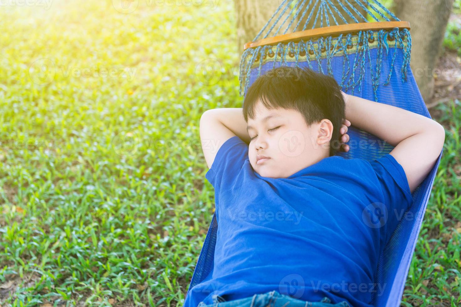 obese fat boy sleep on cradle photo