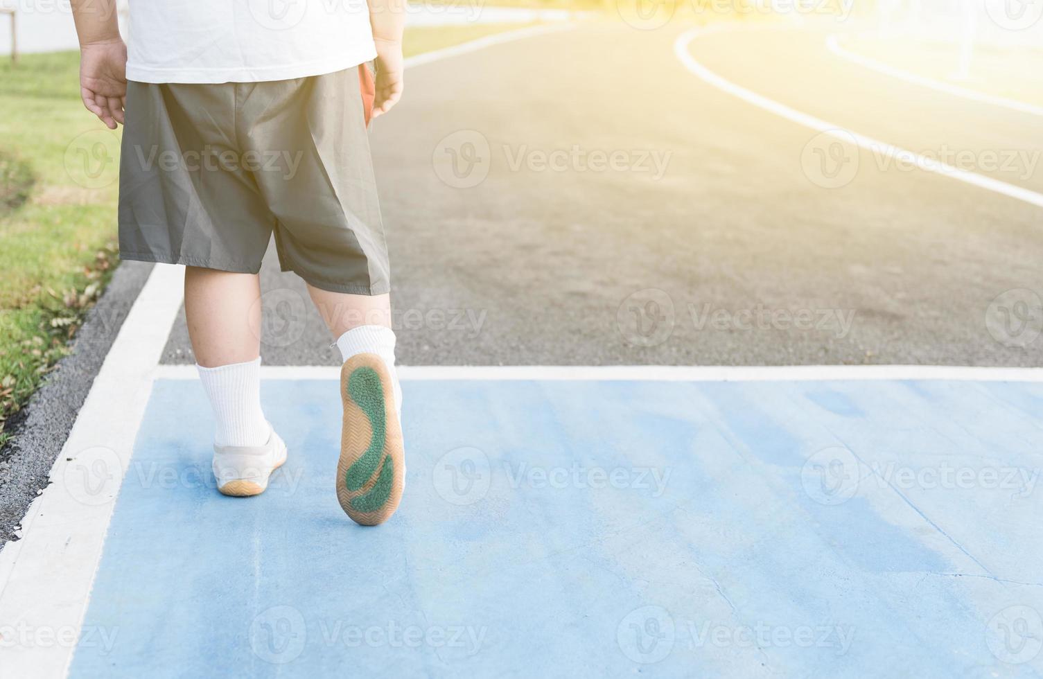 obese fat boy walking on healthy park photo
