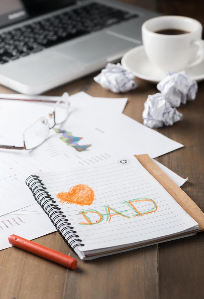 love dad text on notebook on workdesk. photo