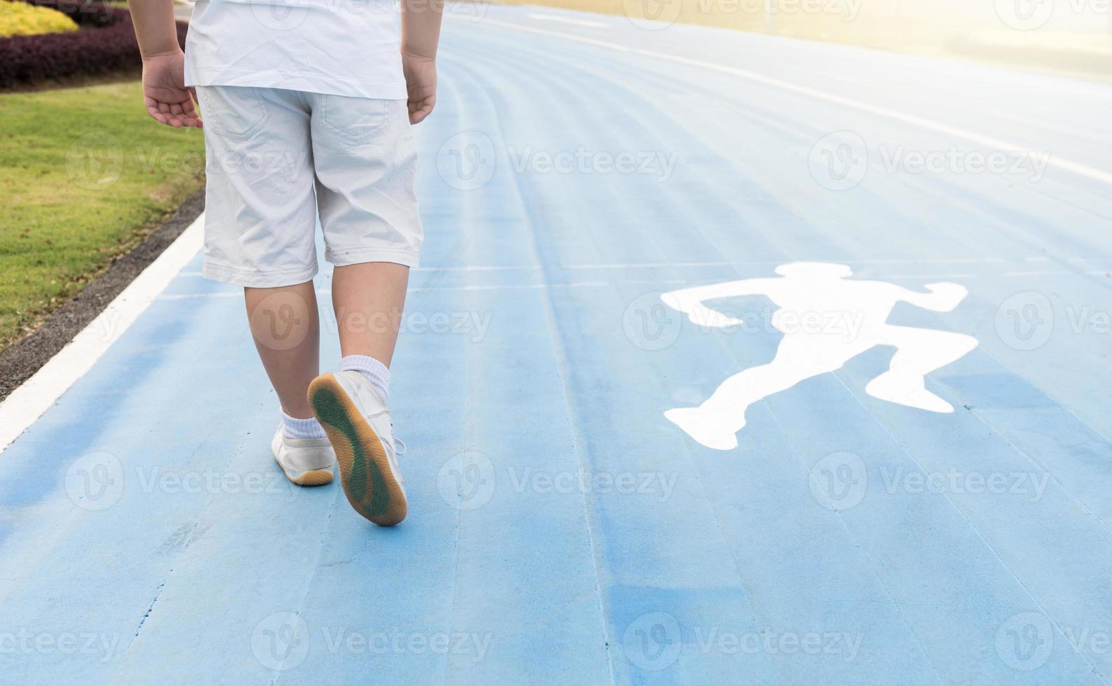 Obese fat boy running on park photo