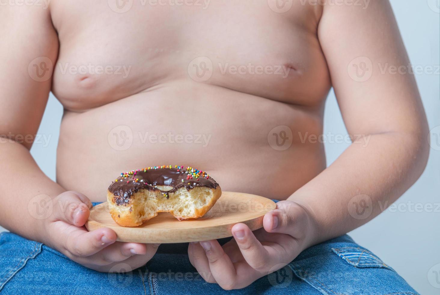 donut in obese fat boy photo