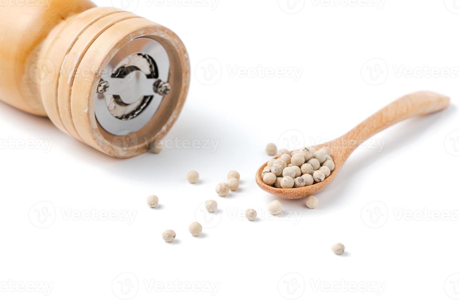 pepper on wood spoon photo