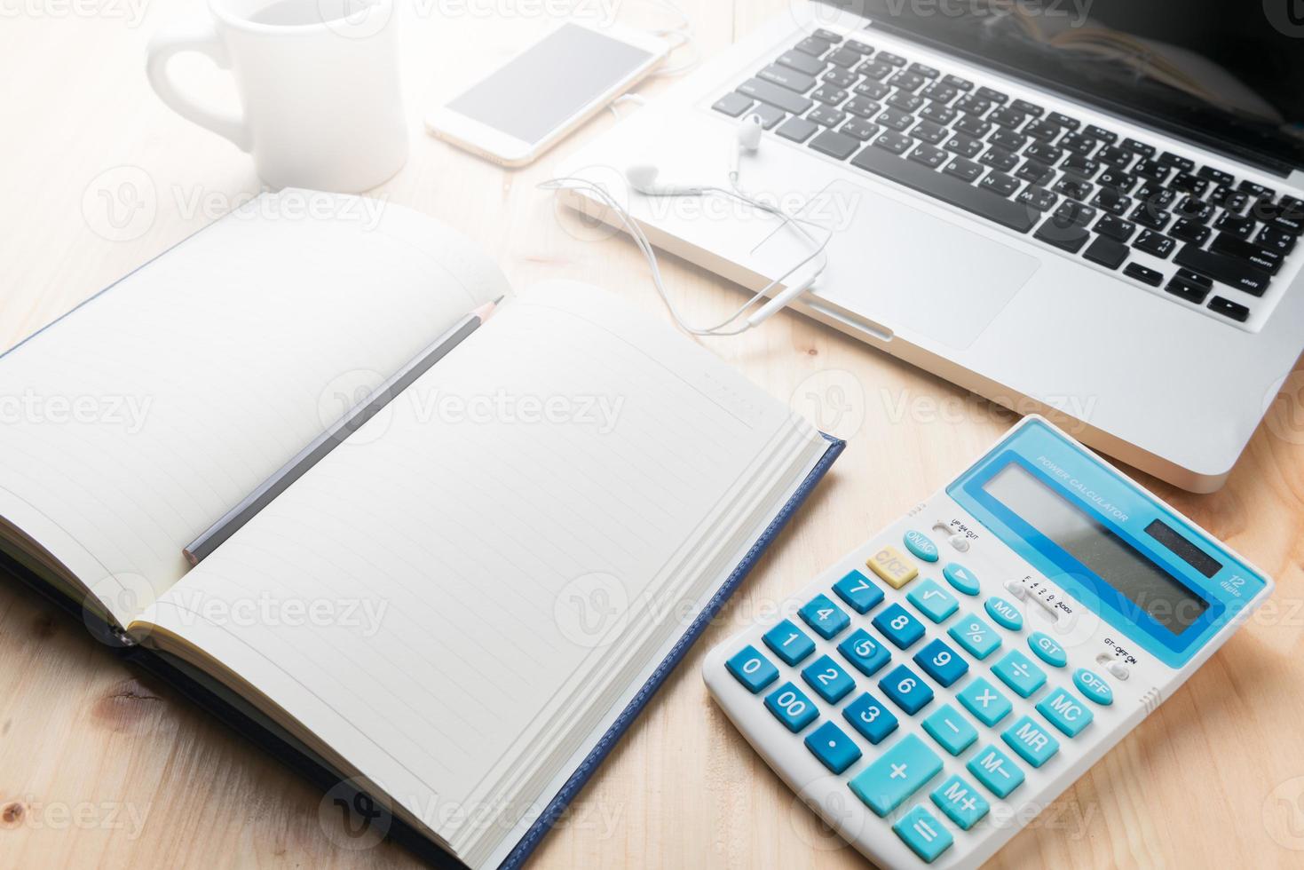 blank notebook with calculator and laptop photo