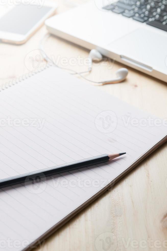 black pencil on blank notebook photo
